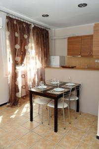 a dining room with a table and some chairs at Kavala's central apartment in Kavála