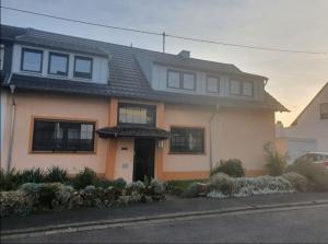 aige house with a black roof on a street at Ferienhaus-Weitsicht in Sankt Wendel