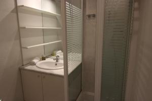a bathroom with a sink and a shower at Vanoise Appartements VTI in Val Thorens +86 photos