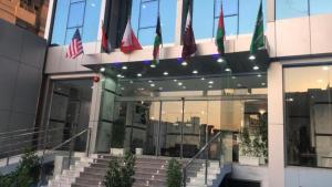 een groep vlaggen die buiten een gebouw vliegen bij Atlantis Suites Hotel in Koeweit