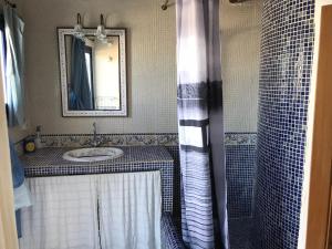 ein Bad mit einem Waschbecken und einer Dusche mit einem Spiegel in der Unterkunft Mirador de la Virgen Ático con terraza y estudio sin terraza in Ibiza-Stadt