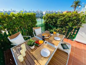 a wooden table with food on top of a balcony at Bungalow Dunaflor Verde 4 in San Bartolomé
