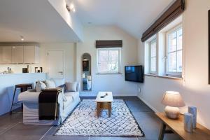 a living room with a couch and a table at Apartments in the countryside near Brussels in Lasne