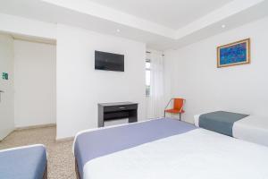 En eller flere senge i et værelse på Ayenda 1251 Oasis
