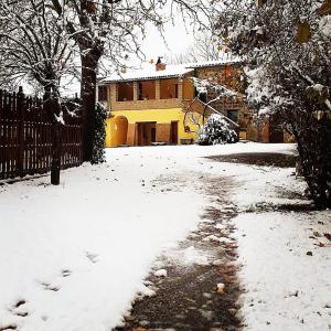 un vialetto coperto da neve di fronte a una casa di Agriturismo Podernuovo ad Acquapendente