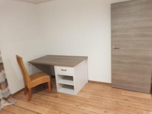 a desk in a room with a chair and a door at FEWO Jürgen und Conny in Babenhausen