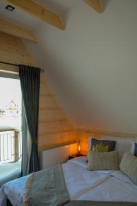 a bedroom with a large bed in a attic at Okno na gorce in Frydman +43 photos