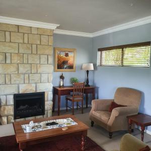 a living room with a couch and a fireplace at Villa Mohau 178 in Clarens