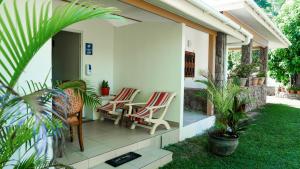 eine Terrasse mit Stühlen und einem Tisch auf einem Haus in der Unterkunft Villa Antonia in La Digue