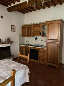 a kitchen with wooden cabinets and a stove top oven at Agriturismo Pietramora in Pitigliano +50 photos