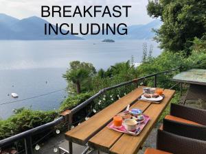 a picnic table with a breakfast overlooking the water at BnB122 bed&breakfast in Ascona