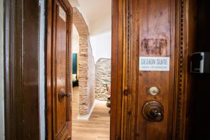 a hallway with a sign on a wooden door at Design Suite Cinque Terre La Spezia in La Spezia