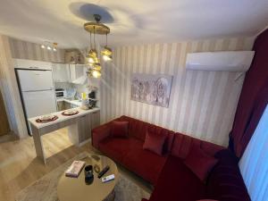 a living room with a red couch and a table at Classic Suite SS5 in Istanbul +8 photos