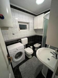 a small bathroom with a toilet and a sink at Kuća za odmor IVKOVIĆ in Kupres +8 photos