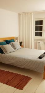 a bedroom with a large white bed with a window at Kolbergarden in Olsztyn