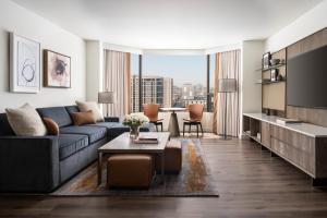 a living room with a couch and a table at Four Seasons Hotel Houston in Houston