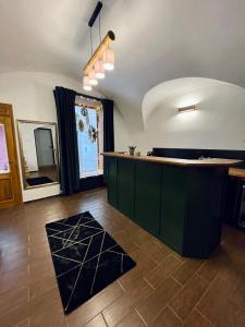 a kitchen with a green counter and a tile floor at Dorfel in Košice