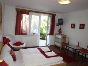 a living room with a bed and a window at Ubytování ABC in Český Krumlov