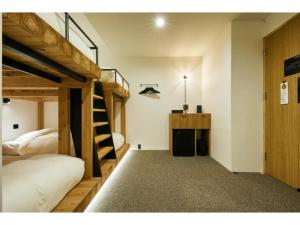 a room with two bunk beds and a desk at mizuka Daimyo7-unmanned hotel - Vacation STAY 05274v in Fukuoka