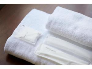 a pile of towels sitting on top of a table at mizuka Daimyo7-unmanned hotel - Vacation STAY 05274v in Fukuoka