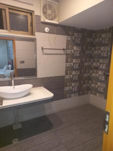 a bathroom with a sink and a shower at Hotel Executive One in Multan