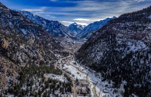 an aerial view of a mountain valley with snow at Ouray Riverside Resort - Inn & Cabins in Ouray