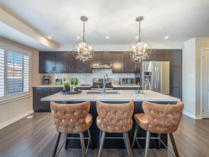 a kitchen with a large island with bar stools at Boutique 3Br+Study Townhouse - Oakville in Oakville