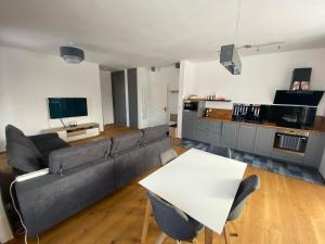 a living room with a couch and a table at 3 Sosny Apartments - Suite 1 in Tatranska Strba