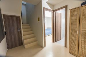 a hallway with stairs leading to a bedroom at Raise Spetses Sea View Villa in Spetses