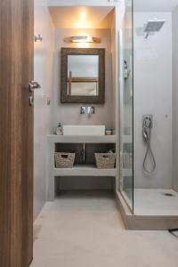a bathroom with a sink and a mirror at Raise Spetses Sea View Villa in Spetses