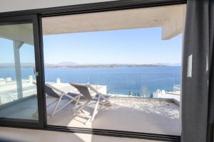 a view of the ocean from the balcony of a house at Raise Spetses Sea View Villa in Spetses