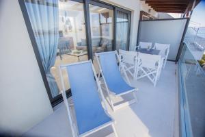 a balcony with a table and chairs on a balcony at Raise Spetses Sea View Villa in Spetses