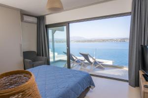 a bedroom with a bed and a view of the ocean at Raise Spetses Sea View Villa in Spetses