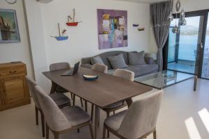 a living room with a table and chairs and a couch at Raise Spetses Sea View Villa in Spetses