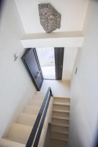 a staircase in a house with a window at Raise Spetses Sea View Villa in Spetses
