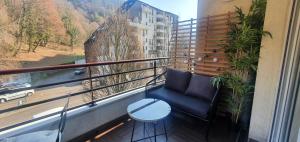 a balcony with a blue chair and a table at La Perle du Semnoz in Annecy