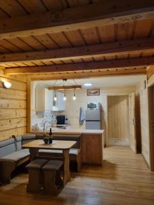 a kitchen and living room in a log cabin at Domki U Uli in Wisła