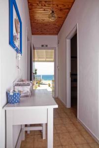 a kitchen with a table and a view of the ocean at Villa Elpida in Agios Georgios