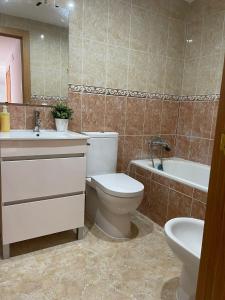 a bathroom with a toilet and a sink and a tub at UIM Mediterraneo ATICO Poeta 8 Wifi in Puerto de Sagunto +11 photos