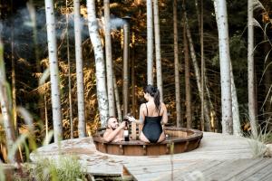 a man and a woman sitting in a hot tub at Leśna Kąpiel in Karpacz