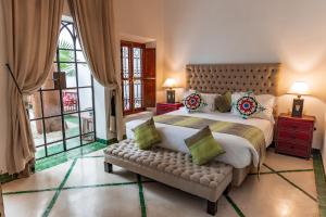 A bed or beds in a room at Riad Luciano Hotel and Spa