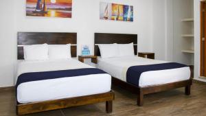 Tempat tidur dalam kamar di José y Glendy Hotel