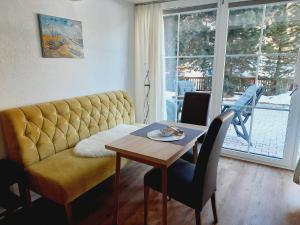 a living room with a couch and a table at Haus Schranz, Fuhrmannsloch in Nauders