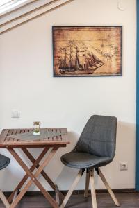 a table and a chair next to a table with a ship at Nautica Room 1 - Old Town in Dubrovnik
