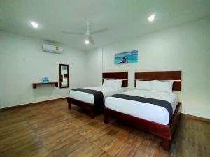 Tempat tidur dalam kamar di José y Glendy Hotel