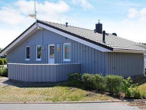 ein blaues Haus mit Dachschräge in der Unterkunft Three-Bedroom Holiday home in Grömitz 19 in Grömitz
