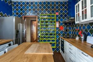 a kitchen with a wooden table and a blue wall at Holiday villa in elite residential area of Faro in Faro