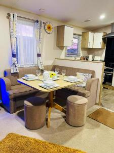 a kitchen and living room with a table and chairs at The Sunflower Luxury caravan at Tattersall lakes in Tattershall