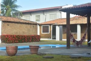 a house with a swimming pool in a yard at Casa aconchegante com piscina e muito espaço verde in Aracaju