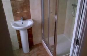 a bathroom with a sink and a shower at Student/one person accommodation flat in London